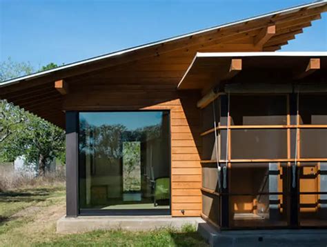 screen house with white metal roof|roof overhang over screen wall.